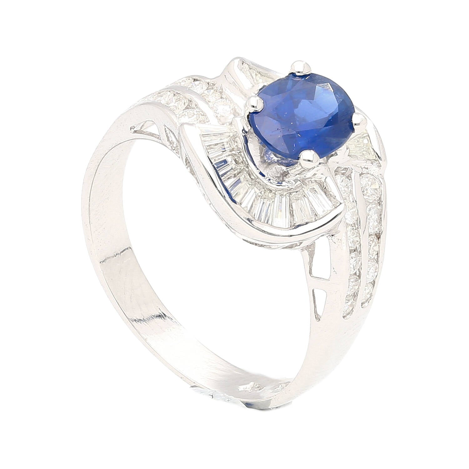 Natural 1.14 Carat Oval Cut Blue Sapphire with Round & Baguette Cut Diamonds in a Swirled 18K White Gold Ring Setting